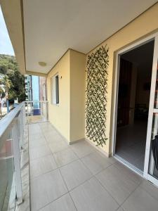 a balcony of a house with a wall with a door at Apartamento na Praia Grande Ubatuba in Ubatuba