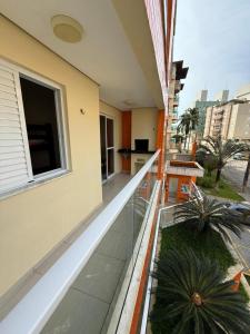 a balcony of a building with two potted plants at Apartamento na Praia Grande Ubatuba in Ubatuba