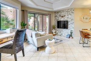 a living room with a couch and a fireplace at 3 Mi to Sabino Canyon Condo with Resort Perks! in Tucson