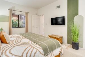 a bedroom with a bed and a flat screen tv at 3 Mi to Sabino Canyon Condo with Resort Perks! in Tucson +19 photos