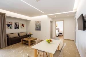 a living room with a white table and a couch at Astir Apartments Kalamata in Kalamata