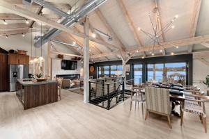 a large room with a dining table and a kitchen at Keenan Beach w/Beach, Heated Pool & Game Room in Mooresville