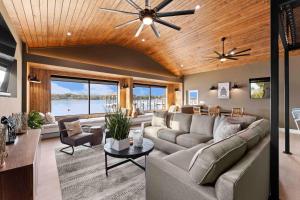 a living room with a couch and a ceiling fan at Keenan Beach w/Beach, Heated Pool & Game Room in Mooresville