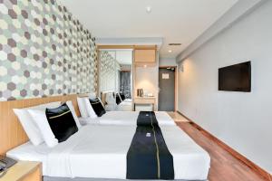 a hotel room with two beds and a television at Sunday Malacca Near Jonker Street Formerly Quayside in Melaka +40 photos