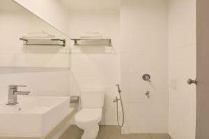 a white bathroom with a toilet and a sink at Sunday Malacca Near Jonker Street Formerly Quayside in Melaka