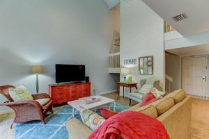 a living room with a couch and a tv at End Unit at Club Villas! This gorgeous, coastal coastal inspired villa is the ultimate beach-pad! in Franklintown