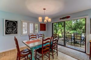 a kitchen and dining room with a table and chairs at End Unit at Club Villas! This gorgeous, coastal coastal inspired villa is the ultimate beach-pad! in Franklintown
