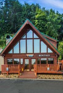 a building with glass windows and stairs in front at Bear Camp By The Night in Pigeon Forge