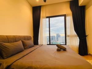 a bedroom with a large bed with a large window at Lucentia residences by BrightNest in Kuala Lumpur +81 photos