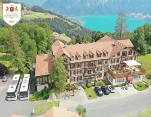 an aerial view of a hotel with a parking lot at Beatenberg Resort & Spa in Beatenberg Interlaken in Beatenberg