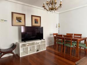 a dining room with a table and a television at 18 Torres Pasaje de los Giles in Zaragoza