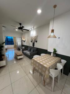 a living room with a table and a couch at ITCC Manhattan Suites by Cozyqa Stay in Donggongon