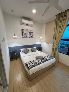 a bedroom with a bed and a large window at ITCC Manhattan Suites by Cozyqa Stay in Donggongon