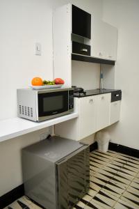 a kitchen with a microwave and a bowl of fruit at 12 Céntrico y Confortable apto Casa Doña Yola in Cartagena de Indias