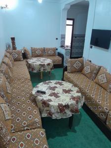 a living room with a couch and a table at Casa maartil in Martil