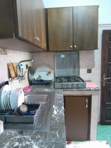 a kitchen counter with a sink and a stove at Casa maartil in Martil
