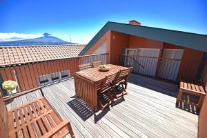 a balcony with two chairs and a table on a deck at Casa da Baía - Guest House in Horta