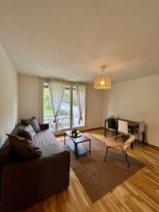 a living room with a couch and a table at Comfort Meets Simplicity 2BR Apartment in Zürich