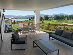 a living room with a couch and a table with a view at Casa con vista lago Rapel in Las Cabras