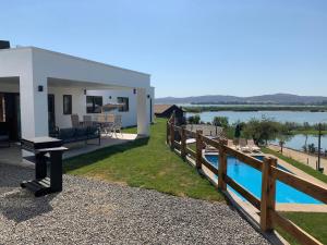 a house with a fence and a swimming pool at Casa con vista lago Rapel in Las Cabras +22 photos