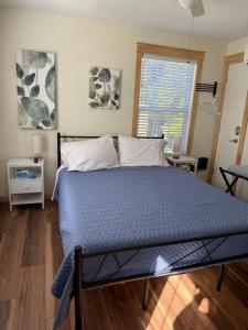 a bedroom with a bed with a blue comforter and a window at 2 Bedroom home near Mammoth Cave NP in Mammoth Cave