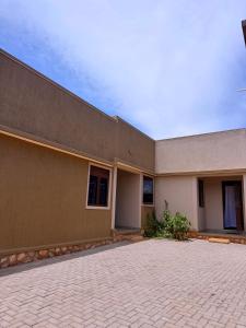 a building with a brick driveway in front of it at Five-Eight Residences in Jinja
