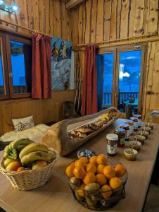 a table with baskets of fruit on top of it at Chalet MontBlanc in La Plagne Tarentaise