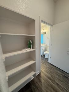 a walk in closet with white shelves in a bathroom at Pleasant apartment in Austin in Leander