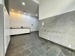 ein leeres Zimmer mit einer Theke und Fliesenboden in der Unterkunft Boqueirão: 50m do mar e perto de tudo! in Praia Grande + 50 Fotos