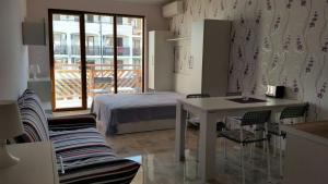 a bedroom with a bed and a table and chairs at Apartments Resort BG in Primorsko +53 photos