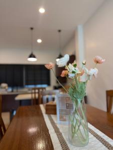 a vase filled with flowers sitting on a table at The FAITH Khaoyai Valley in Ban Rai Khlong Sai