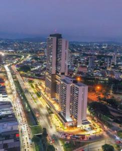 a city skyline with tall buildings and traffic at night at 74m2 Centro, Osasco, 500m da estação, 5 minutos Super Shopping in Osasco