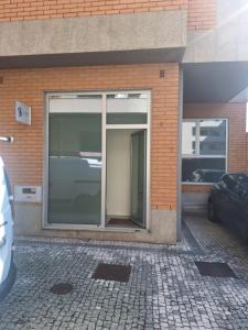 a building with a large glass door on the side of it at Vivas House in Esposende +3 photos