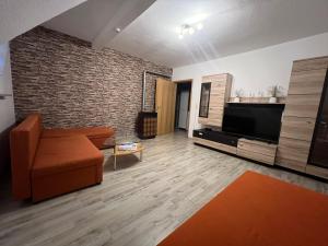 a living room with a couch and a flat screen tv at Wohnung in BadKissingen in Bad Kissingen