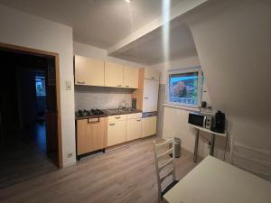 a kitchen with white cabinets and a wooden floor at Wohnung in BadKissingen in Bad Kissingen