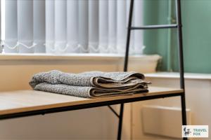 a pile of towels sitting on top of a table at Becky's House: Near Motor Point Arena with Free Parking in Nottingham +38 photos