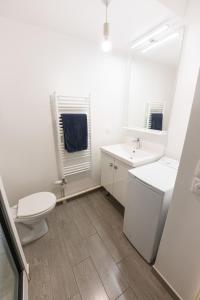 a bathroom with a toilet and a sink and a mirror at Studio à Disneyland Paris in Coupvray