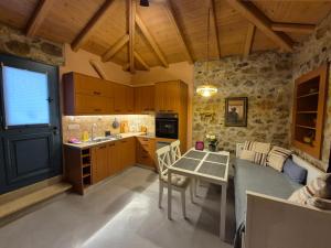 a kitchen with a table and a dining room at Apartment Rustico in Ancient Epidavros +8 photos