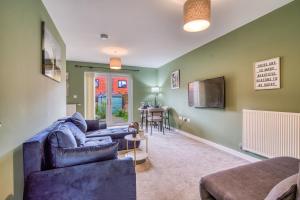 a living room with a couch and a tv at Stylish 2-bedroom home in Salford - 5 guests in Manchester