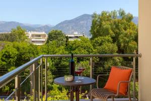 a balcony with a table and two glasses of wine at Astir Apartments Kalamata in Kalamata