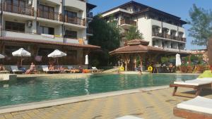 a swimming pool in front of a hotel at Apartments Resort BG in Primorsko