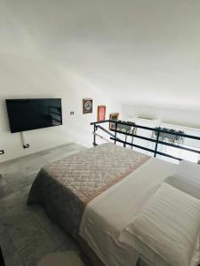 a bedroom with a bed and a flat screen tv at Marble apartment in Prato