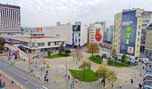 a city with people walking around in a city with buildings at Comfy - Old town apartment Bratislava in Staré Mesto