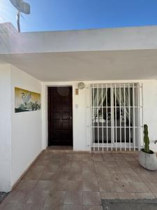 a room with a gate and a door with a cactus at La Laguna Cruz del Eje in Cruz del Eje