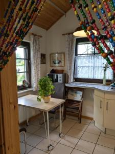 a kitchen with a table with a potted plant on it at Godetied in Hollern