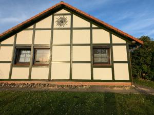 a house with a clock on the side of it at Godetied in Hollern