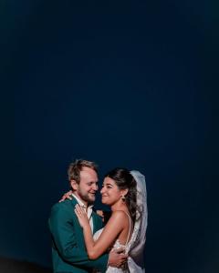 a bride and groom posing for a picture together at MAGIC RUM lUXURY HUSSEN in Wadi Rum
