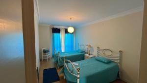 a hospital room with two beds and a window at Superb Position Over the River Historical Center Tomar in Tomar