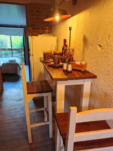 a kitchen with a table with pots and pans on it at Vinoteca cerro in Piriápolis