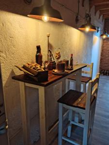 a table with a plate of food and bottles of wine at Vinoteca cerro in Piriápolis